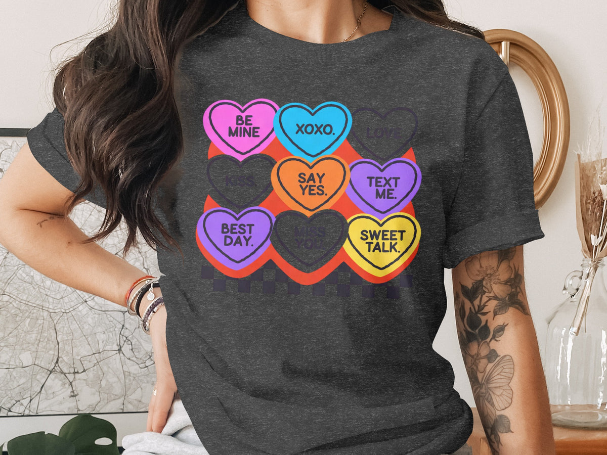 Dark grey t-shirt with colorful hearts: "Be Mine," "XOXO," "Love," "Kiss," "Say Yes," "Text Me," "Best Day," "Miss You," "Sweet Talk."