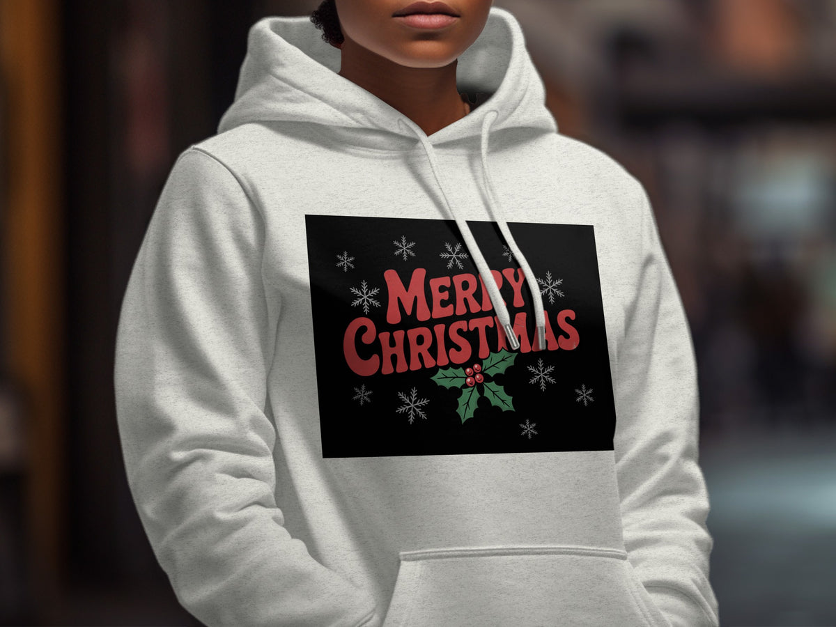 A person wearing a light gray hooded sweatshirt with a Merry Christmas graphic on the chest.