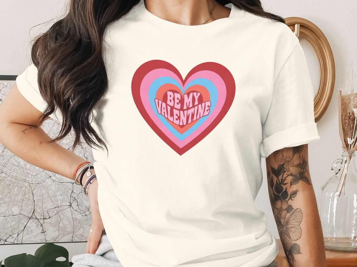 Cream t-shirt with a colorful heart graphic saying "BE MY VALENTINE".