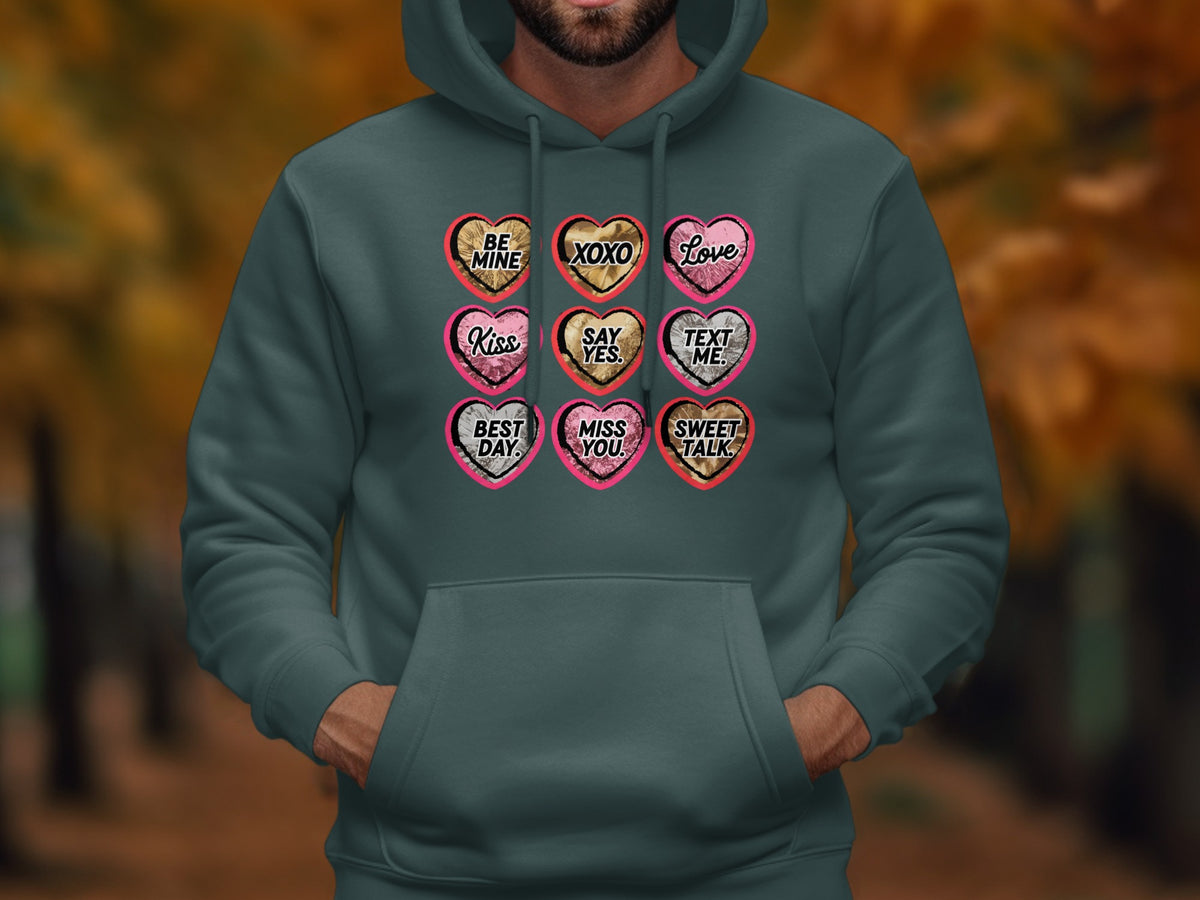 Dark green hoodie featuring nine heart designs with text: Be Mine, XOXO, Love, Kiss, Say Yes, Text Me, Best Day, Miss You, Sweet Talk.