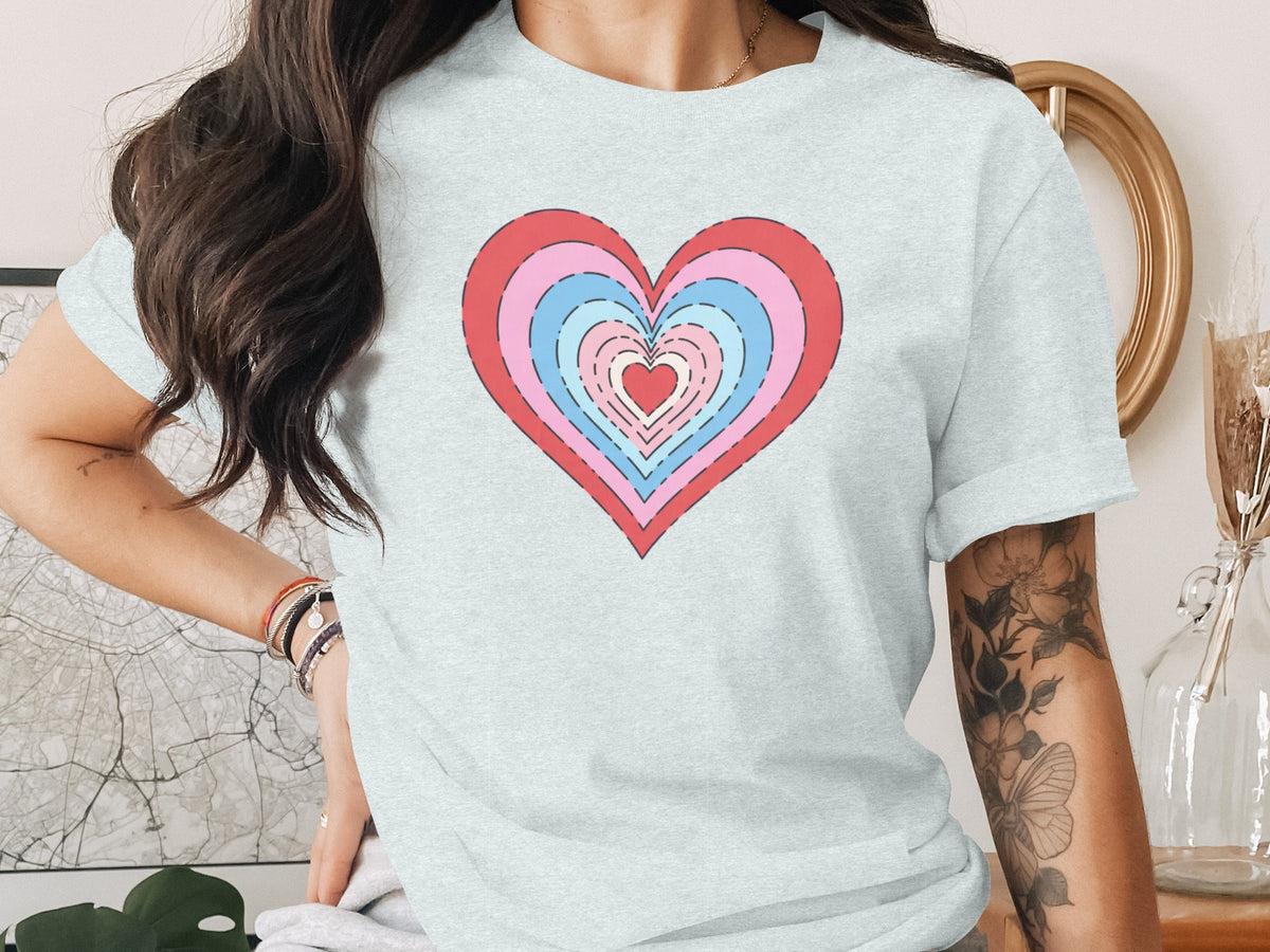 Light blue t-shirt with a multi-layered heart graphic in pink, blue, and red.