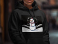 Black hoodie with a smiling snowman graphic and snowflakes.