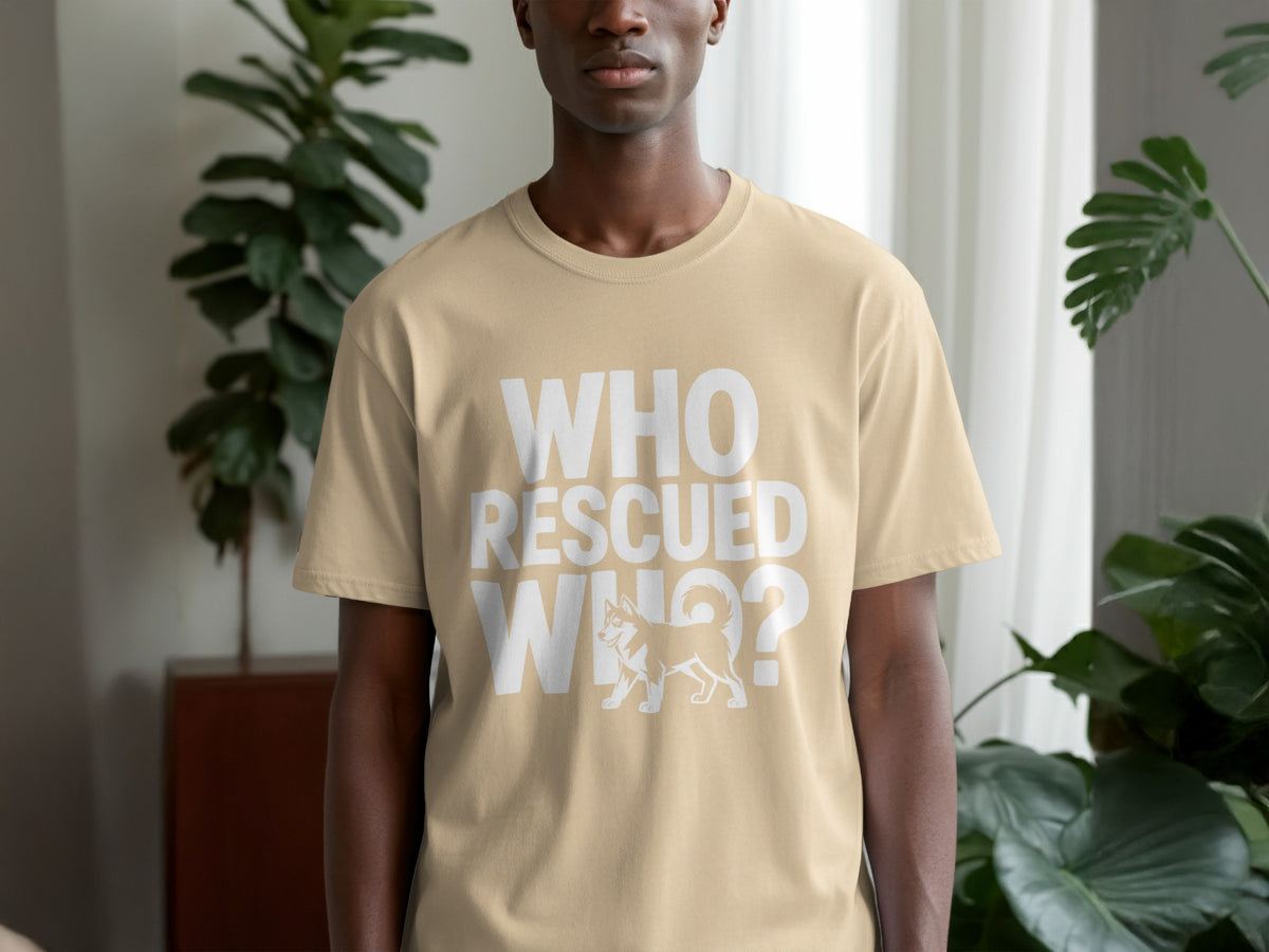 Tan t-shirt with white text "WHO RESCUED WHO?" and a husky illustration.