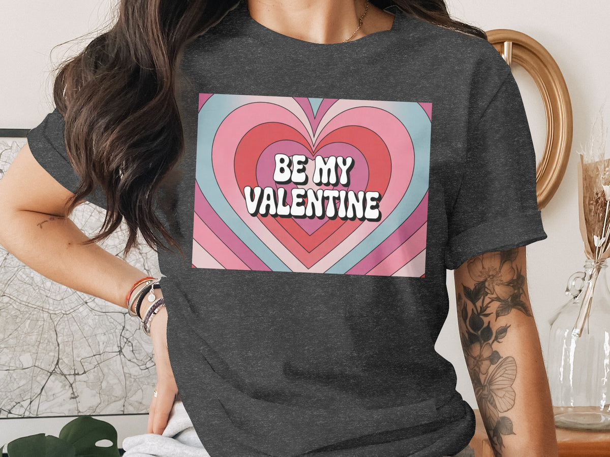 Dark grey t-shirt with "BE MY VALENTINE" text inside a retro heart graphic.