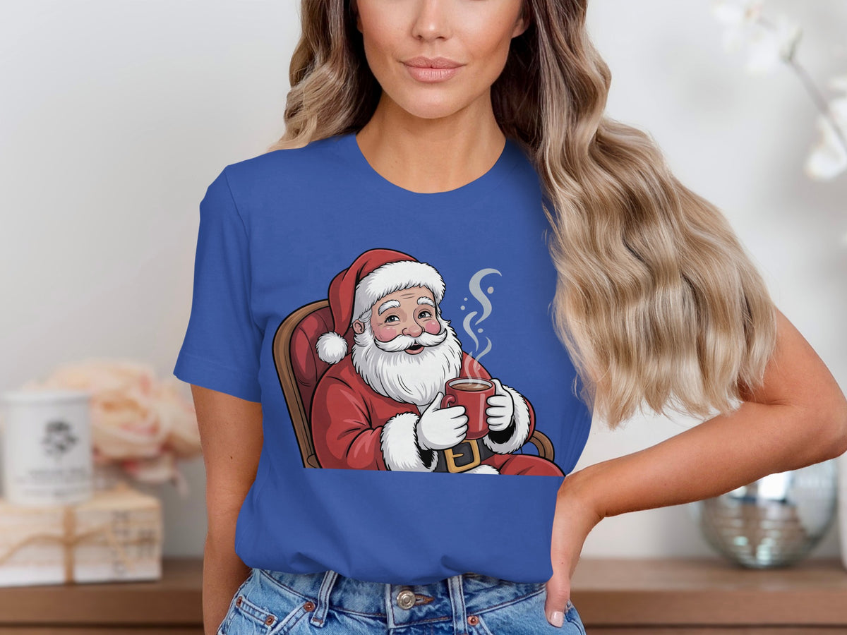Santa Claus sitting in a chair, holding a steaming mug of hot chocolate.