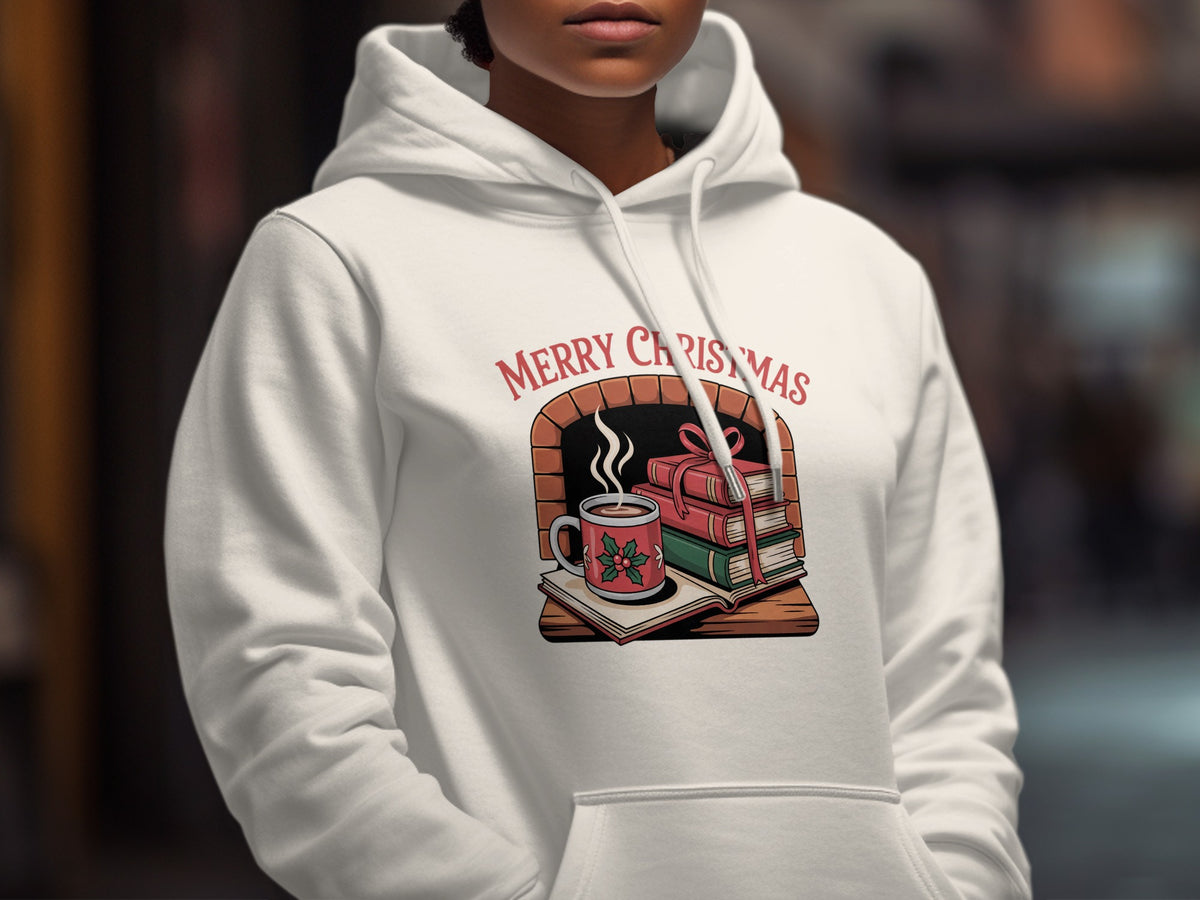 A person wearing a white hooded sweatshirt printed with a Merry Christmas graphic featuring books and a fireplace.