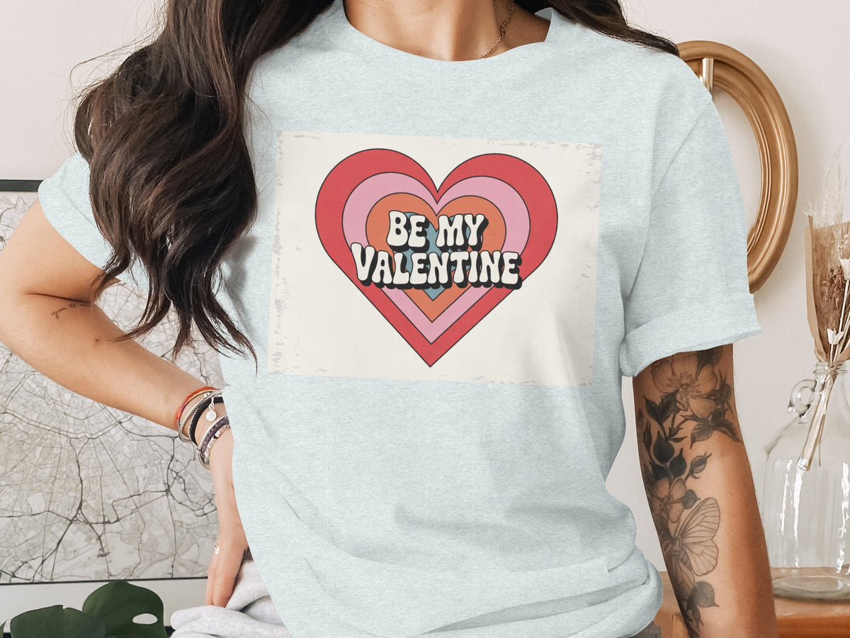 Light blue t-shirt with a graphic heart and the text "BE MY VALENTINE".