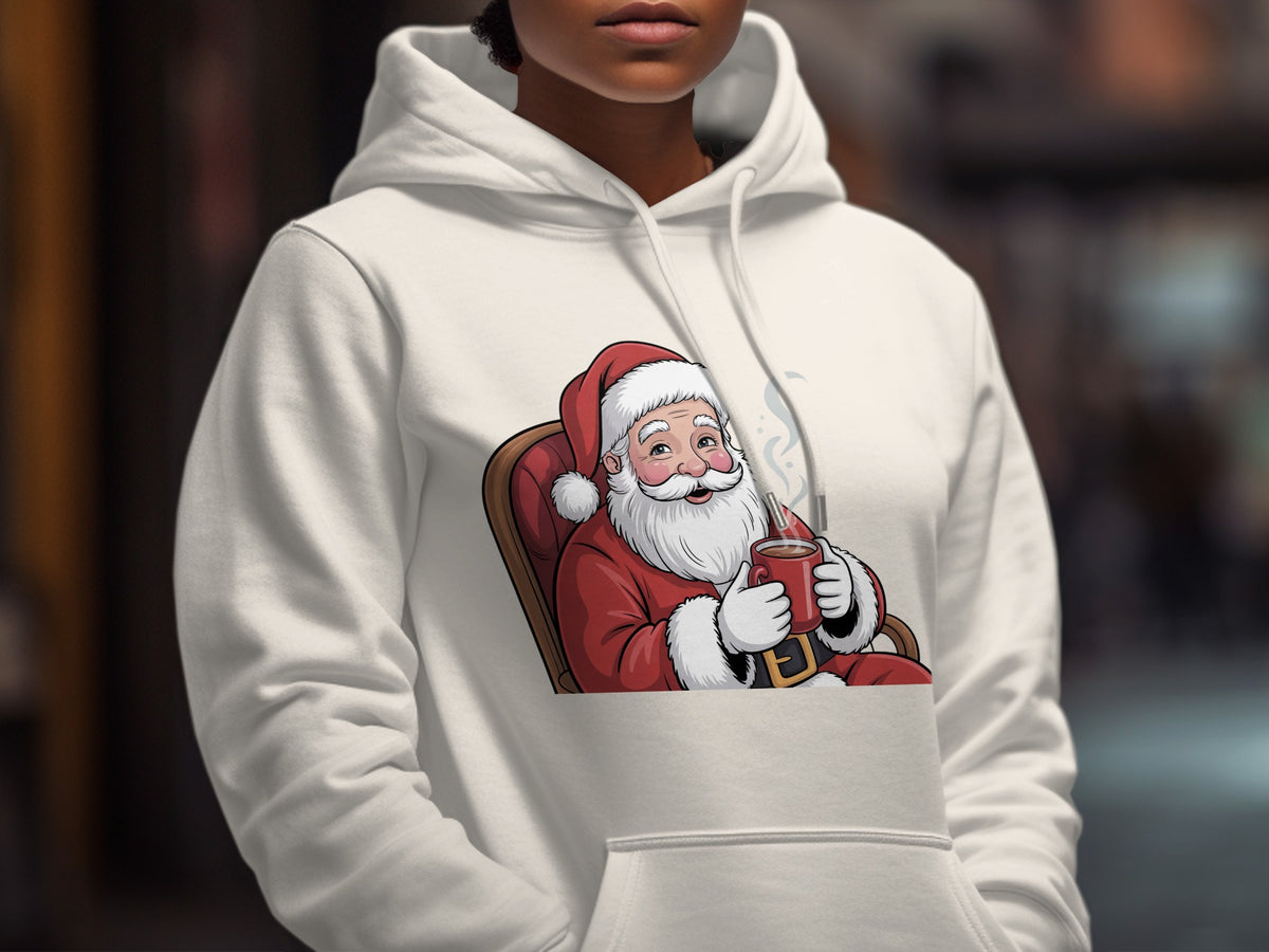 Cream hoodie with cartoon Santa Claus sitting in a chair holding a mug.