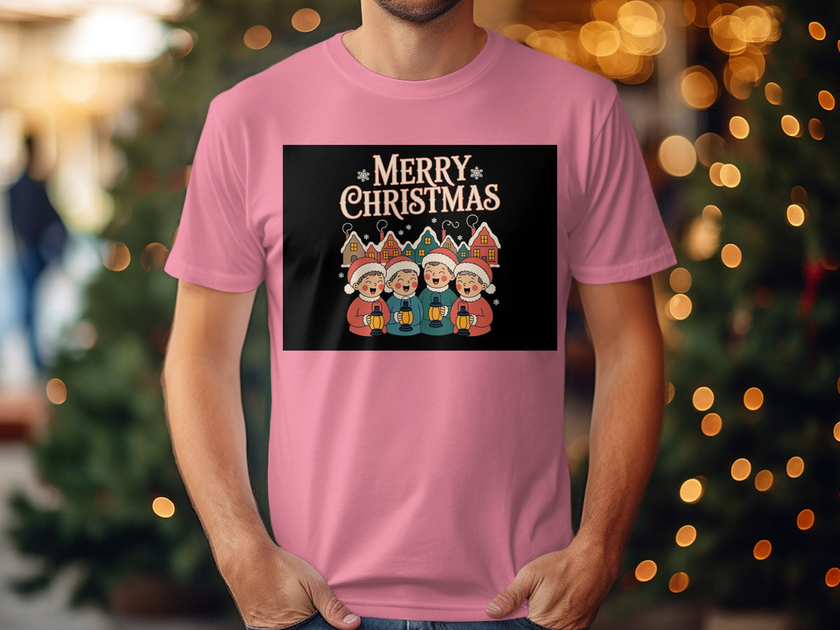 "Merry Christmas" text with carolers and village on a pink t-shirt.