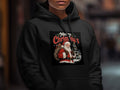 Black hoodie with "Merry Christmas" graphic featuring Santa Claus and a snowy scene.