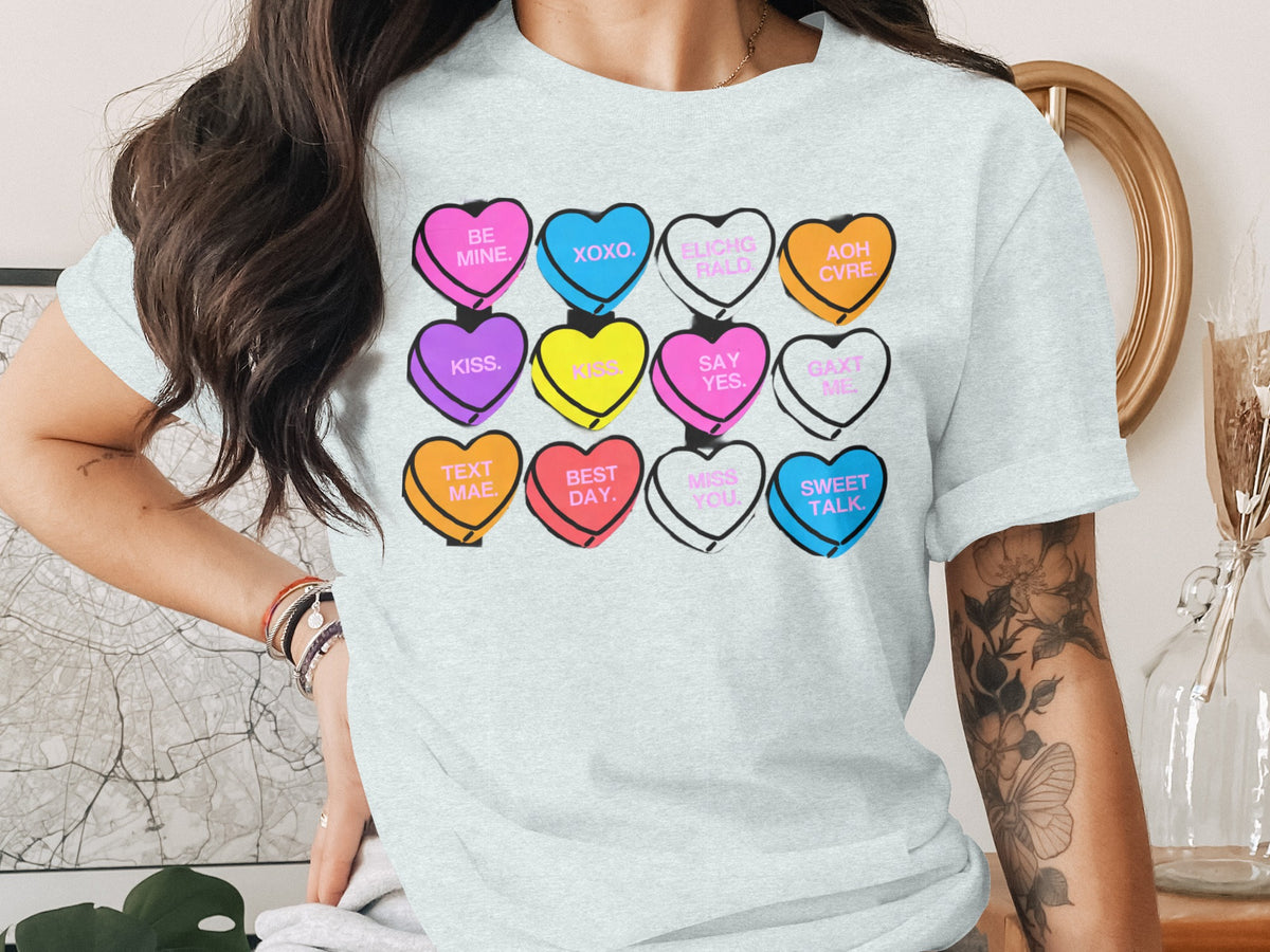 Light gray t-shirt with candy hearts: "Be Mine," "XOXO," "Kiss," "Say Yes," and more.