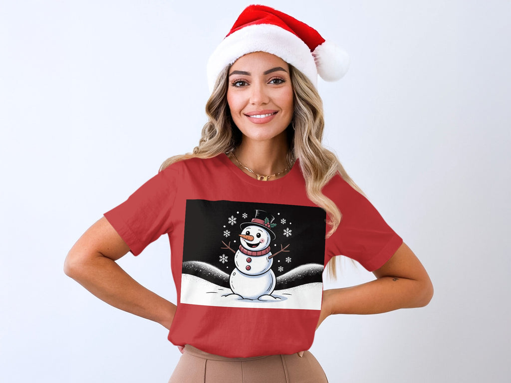 Woman in red t-shirt with a cartoon snowman and snowflakes graphic.