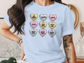 Light blue t-shirt with a graphic of nine conversation hearts with text.