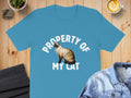 Blue t-shirt with text "PROPERTY OF MY CAT" and Siamese cat illustration.