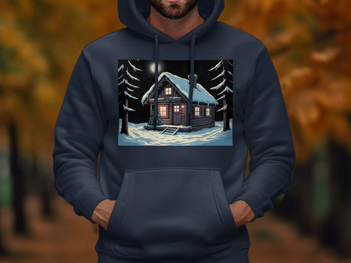 A person wearing a dark blue hoodie printed with a snowy cabin illustration at night.