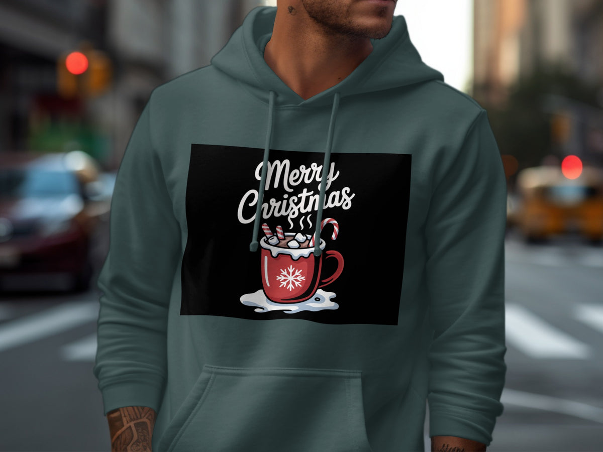 A person wearing a dark teal hoodie printed with a Merry Christmas graphic featuring a hot cocoa mug.