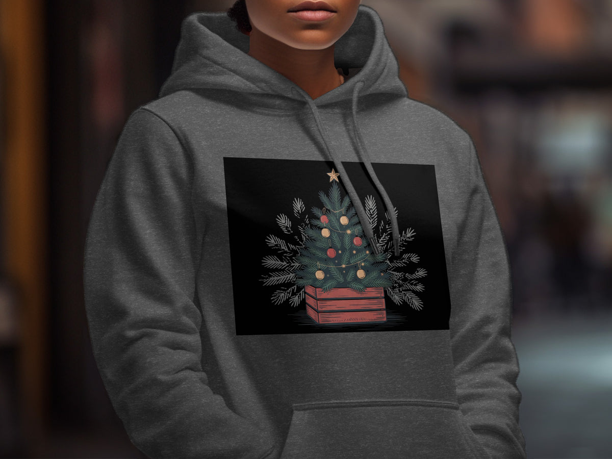 A person wearing a dark gray hooded sweatshirt featuring a graphic of a decorated Christmas tree.
