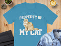 Blue t-shirt with "PROPERTY OF MY CAT" text and a fluffy cat illustration.