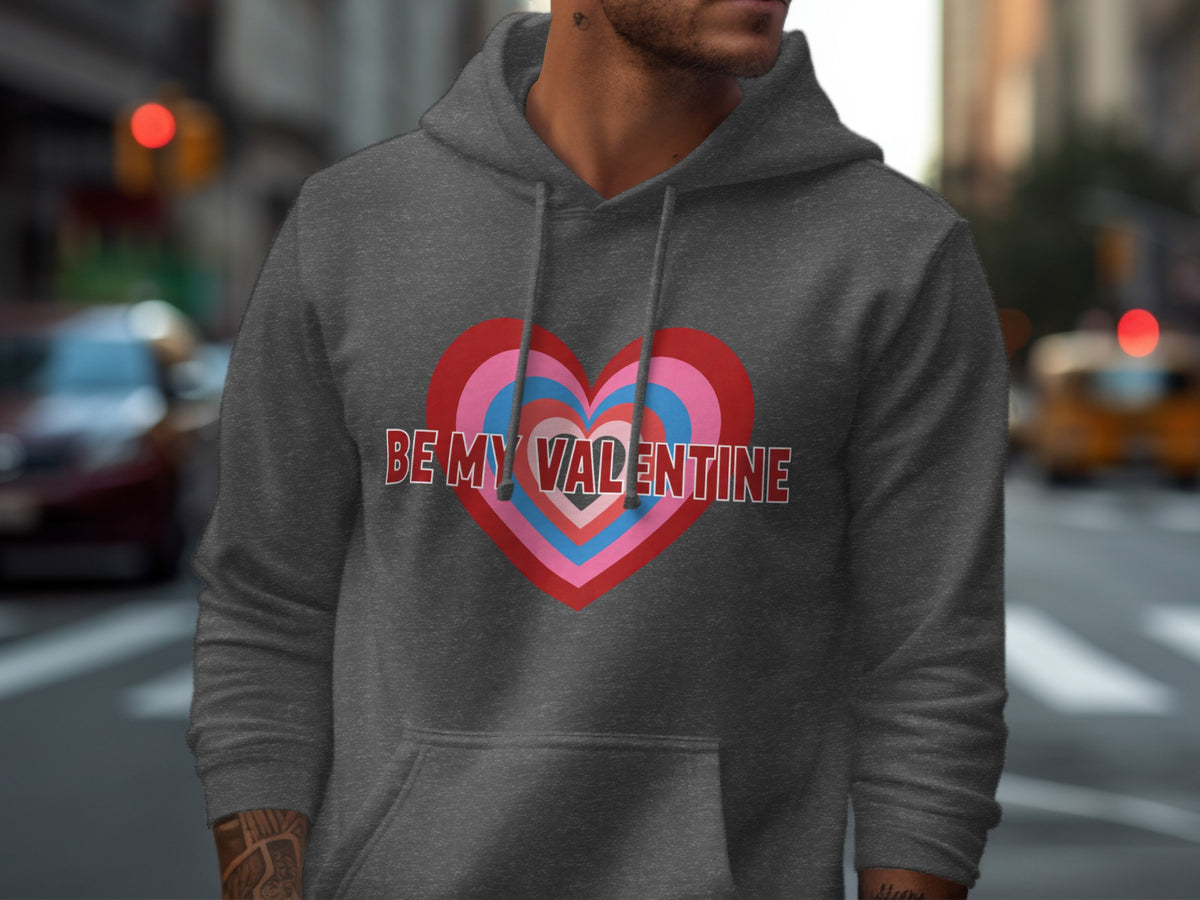 Dark grey hoodie with a colorful heart graphic and "BE MY VALENTINE" text.