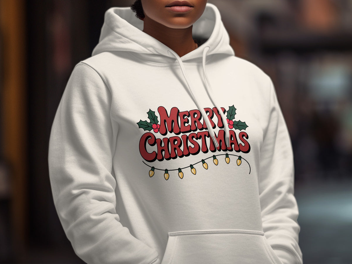 A person wearing a white hooded sweatshirt printed with Merry Christmas text, holly leaves, and string lights.