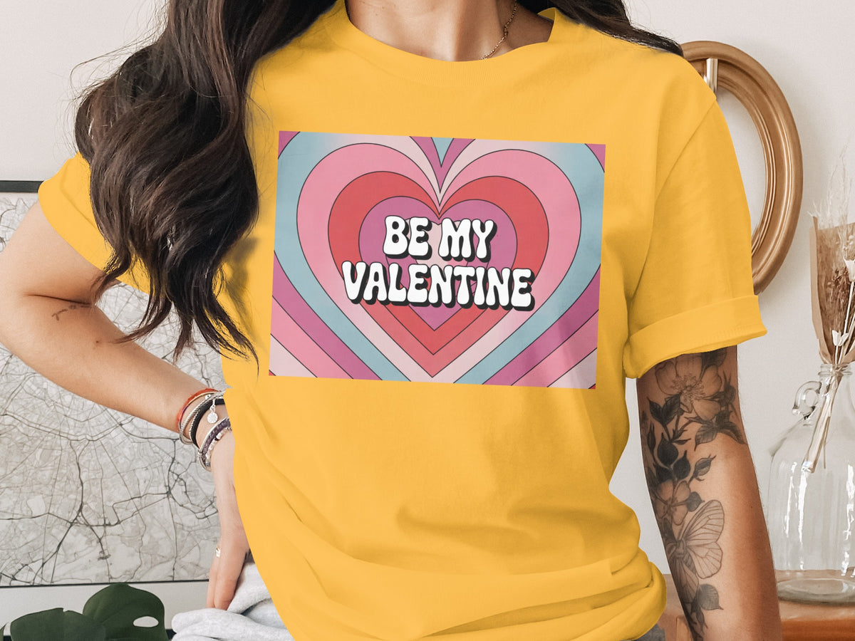 Yellow t-shirt with "BE MY VALENTINE" text over a heart pattern.