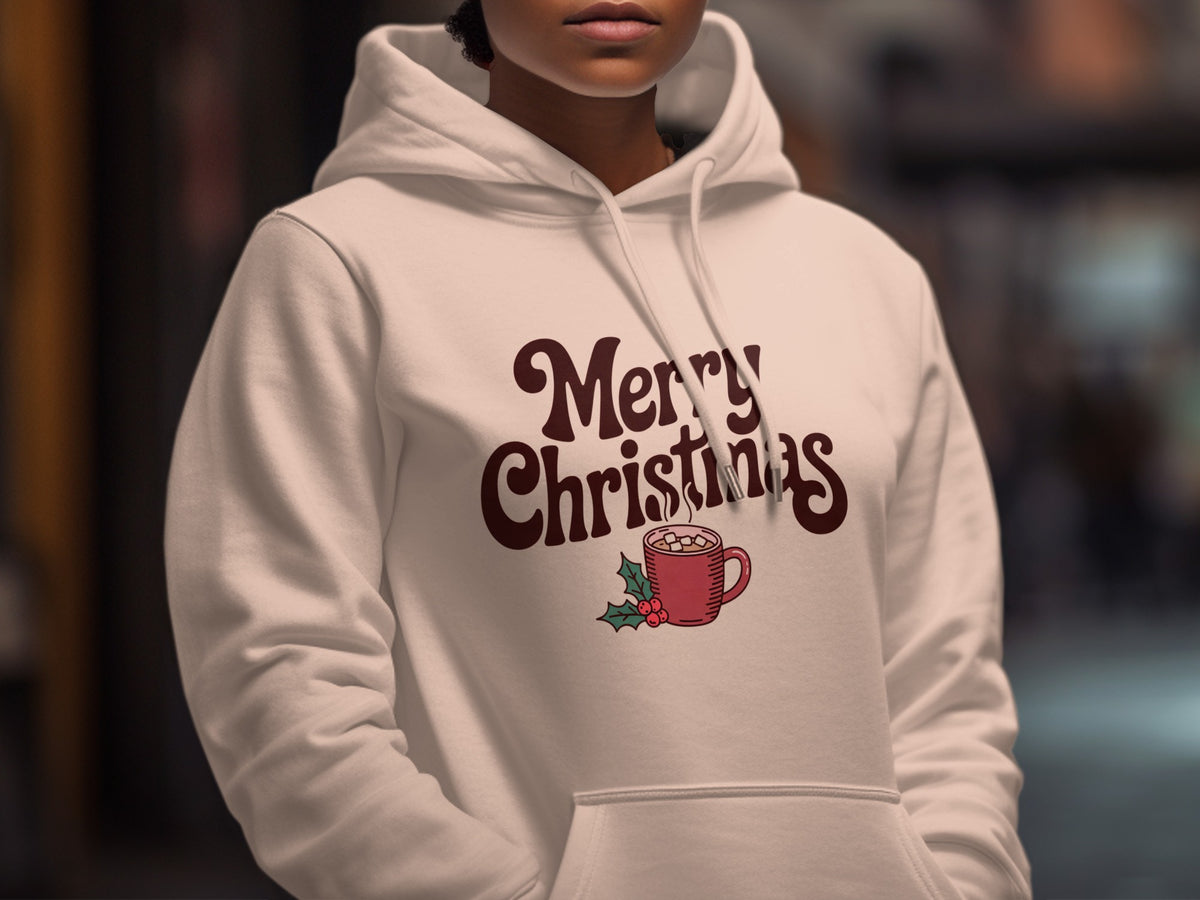 A person wearing a white hooded sweatshirt with Merry Christmas text and a red mug graphic.