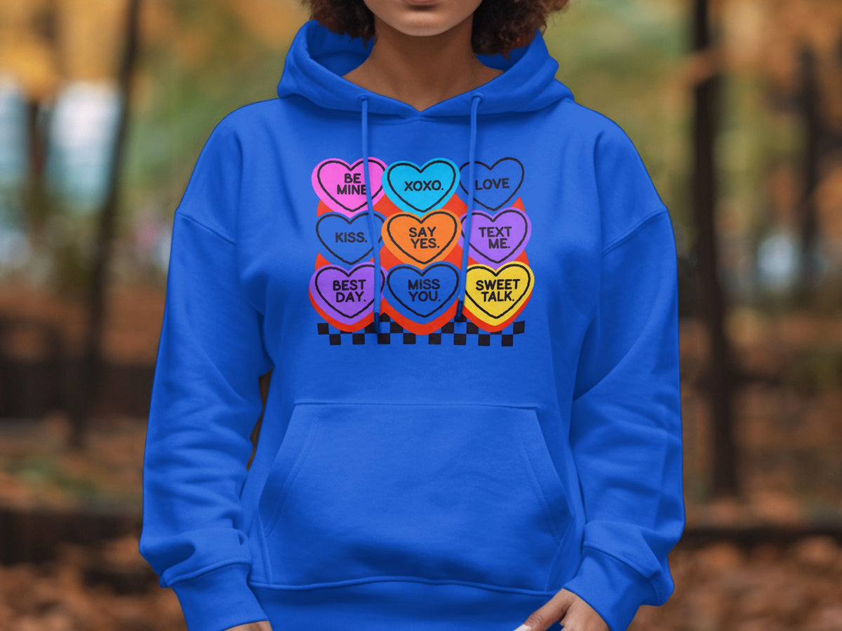 Blue hoodie with colorful hearts: "Be Mine", "Xoxo", "Love", "Kiss", "Say Yes", "Text Me", "Best Day", "Miss You", "Sweet Talk".