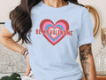 A person wearing a light blue t-shirt featuring concentric hearts and the text Be My Valentine.