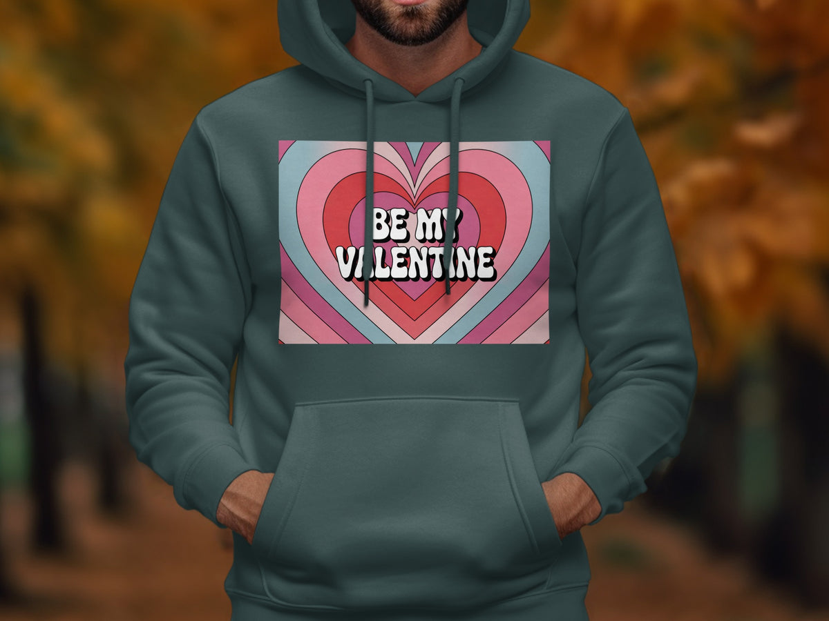 Teal hoodie with "BE MY VALENTINE" graphic on a concentric heart background.
