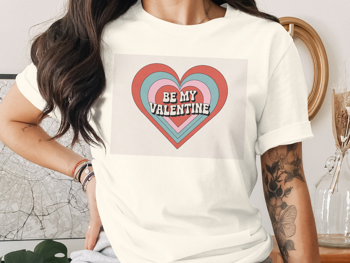 Cream t-shirt with stacked heart graphic saying "BE MY VALENTINE".