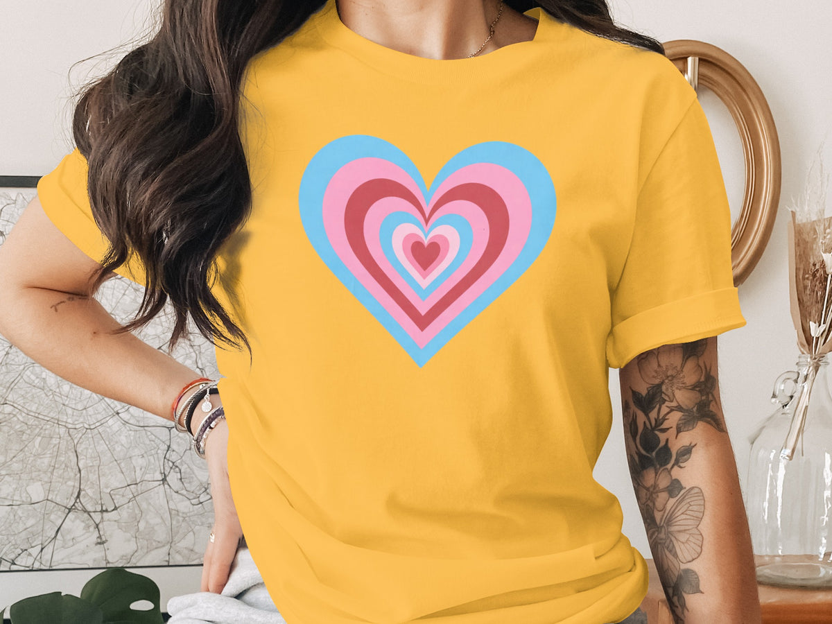 Yellow t-shirt with nested hearts in pink, blue, and red design.