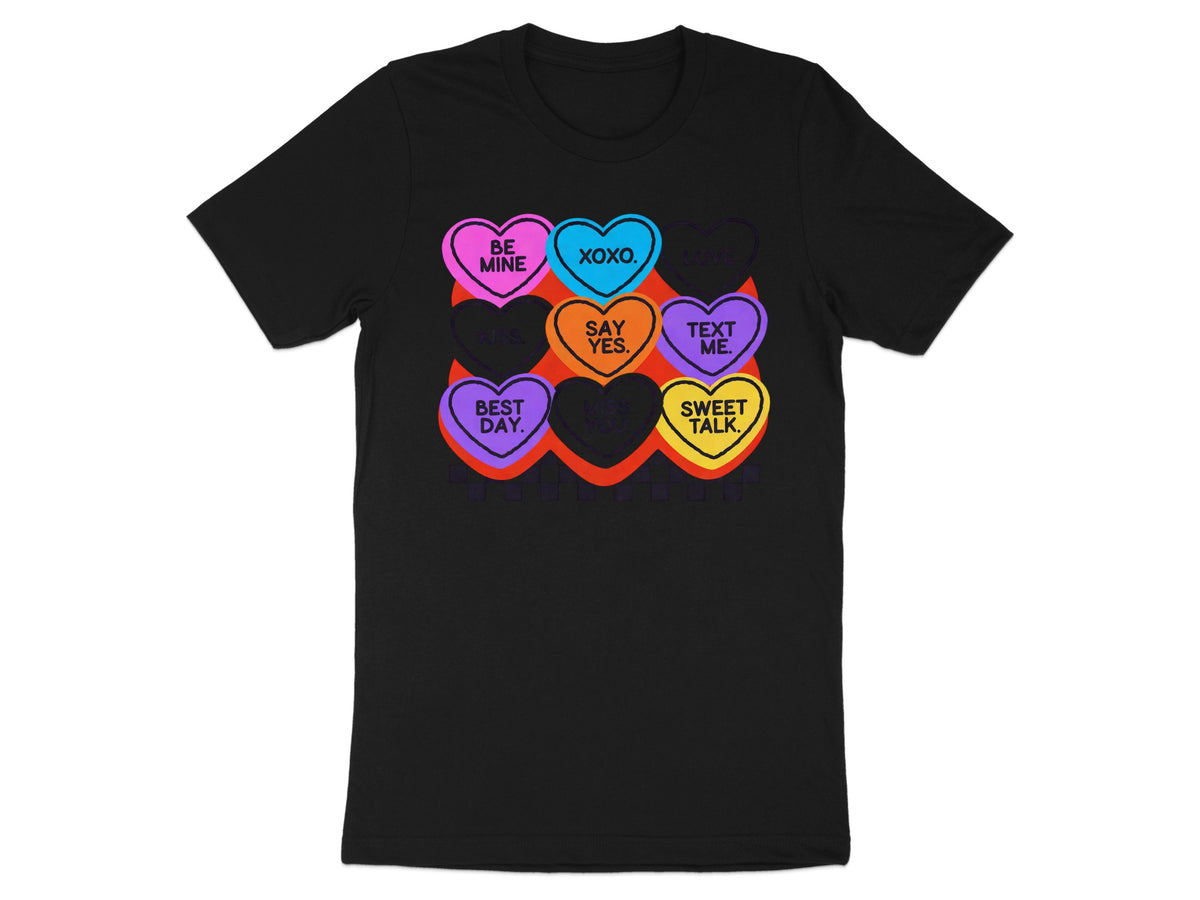 Black t-shirt with colorful candy hearts saying "Be Mine", "XOXO", "Love", "Kiss", "Say Yes", "Text Me", "Best Day", "Miss You", "Sweet Talk".