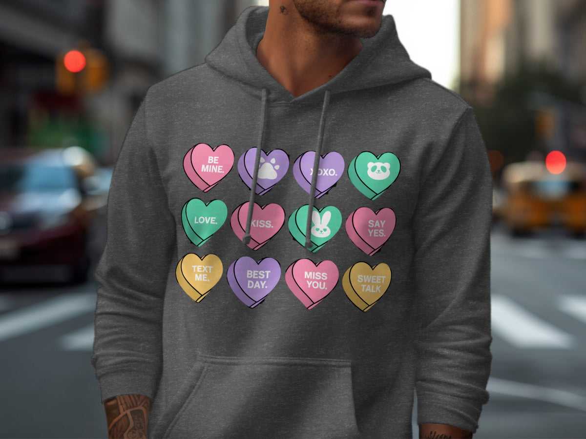 Dark grey hoodie featuring a pattern of heart-shaped candy conversation hearts.