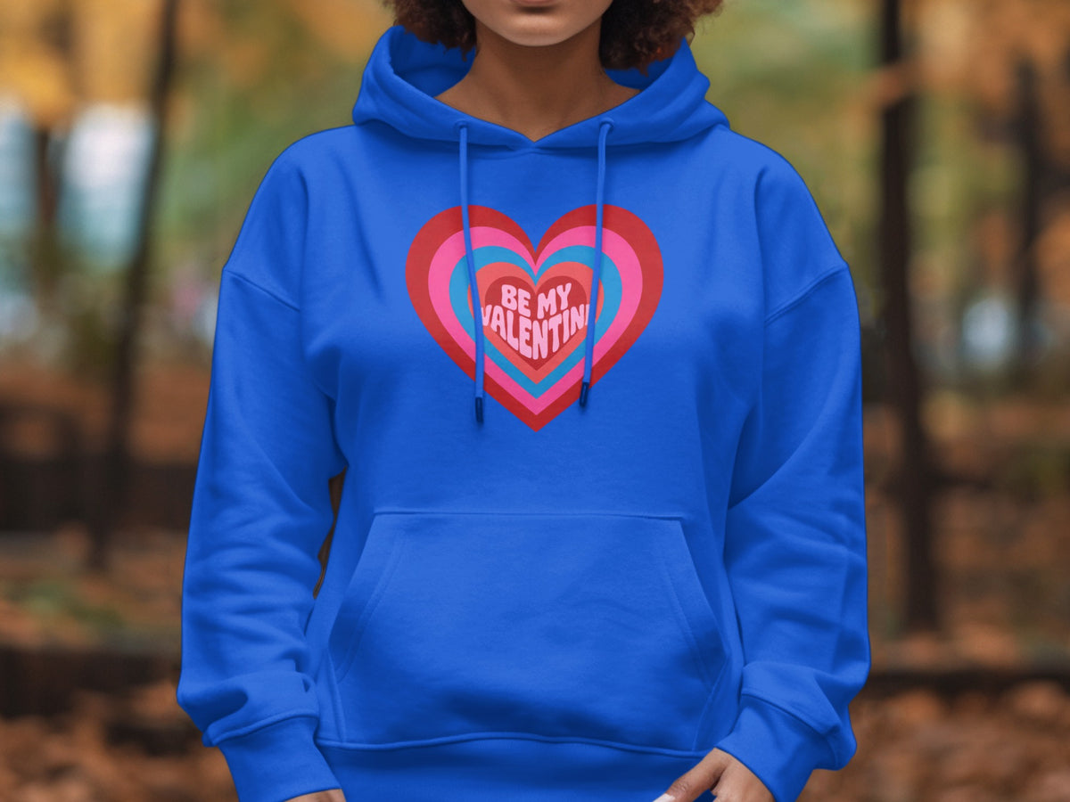 Blue hoodie with concentric hearts graphic reading "BE MY VALENTIN".
