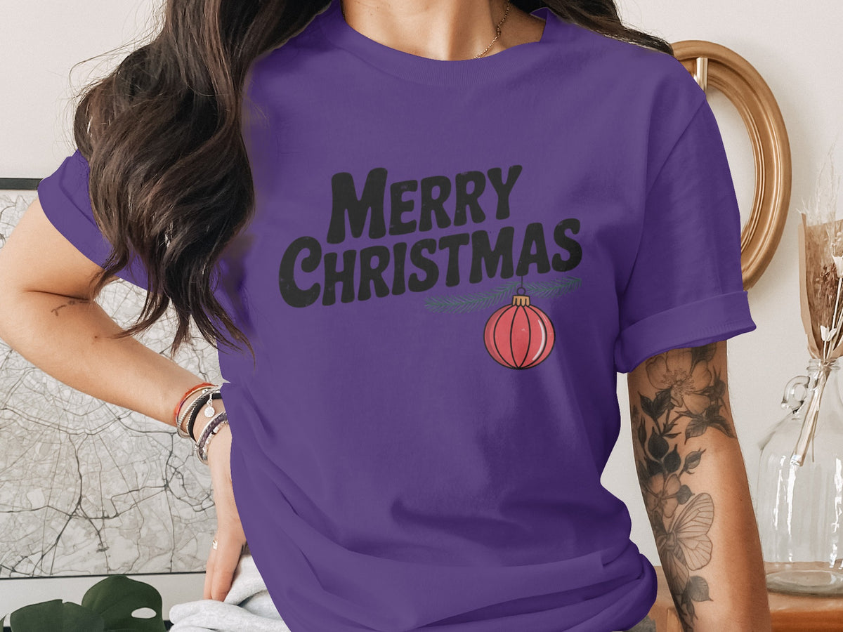 Purple t-shirt with "Merry Christmas" text and a hanging ornament.