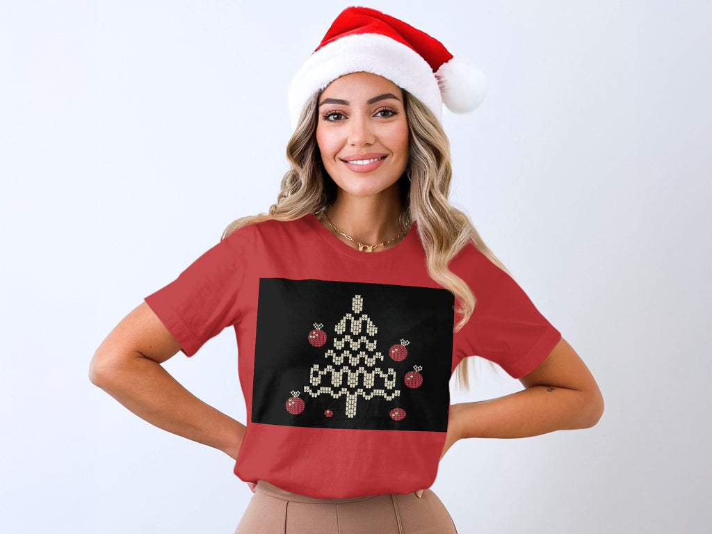 Woman in Santa hat wearing red t-shirt with pixelated Christmas tree and ornaments.