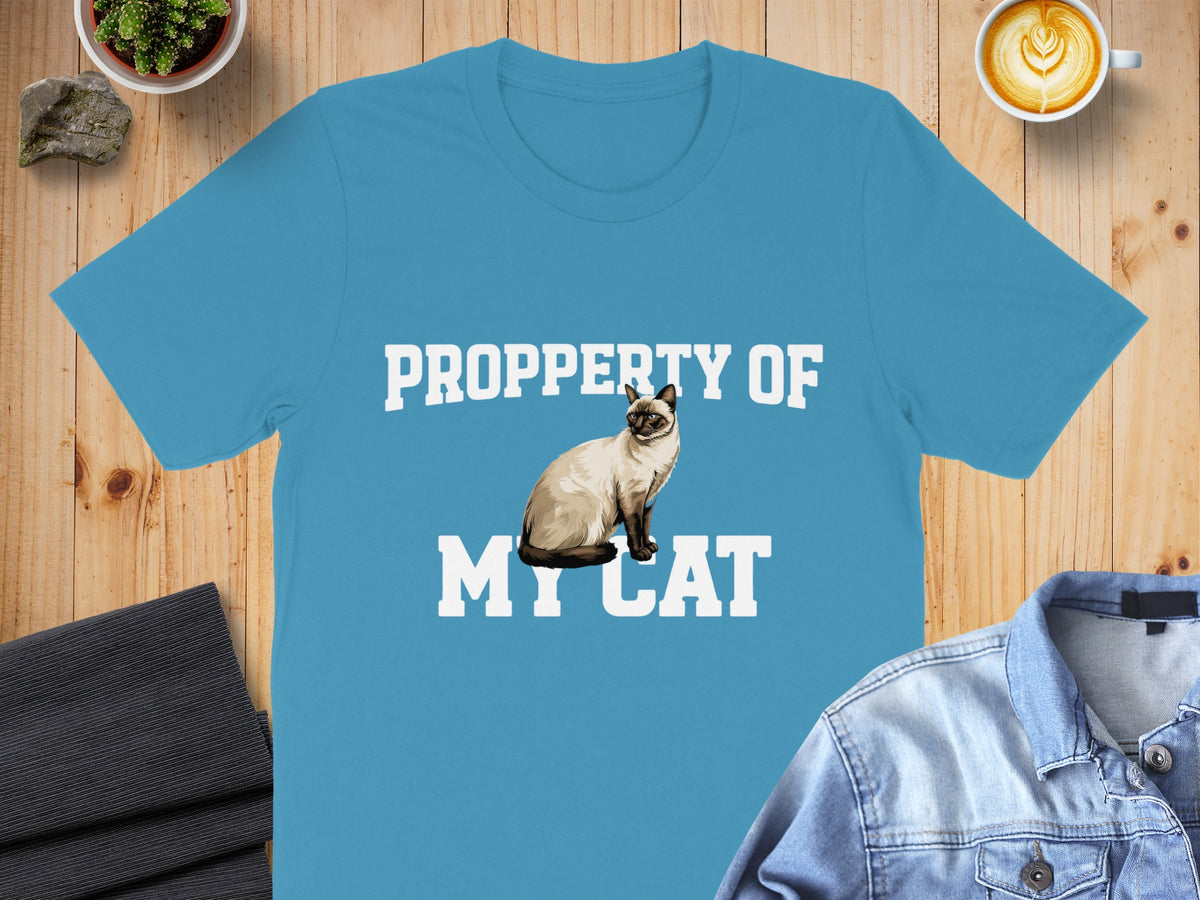 Turquoise t-shirt with white text "PROPPERTY OF MY CAT" and a siamese cat graphic.