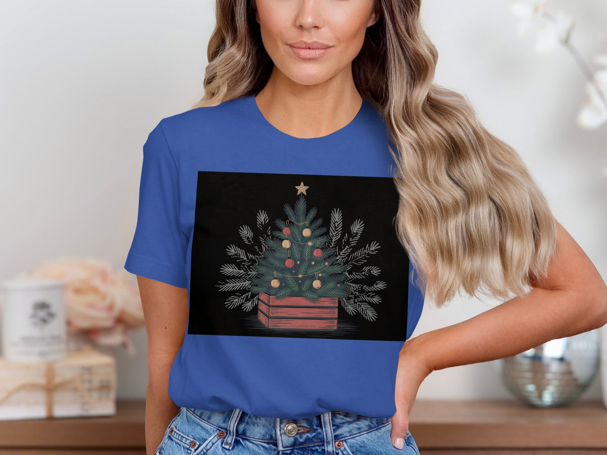 Christmas tree with ornaments in a wooden crate graphic on a blue t-shirt.