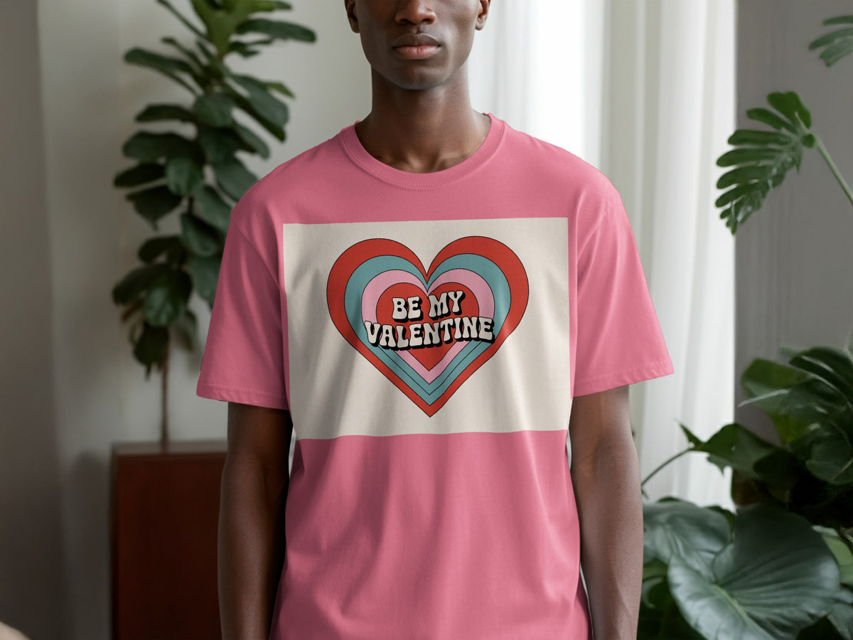 Pink t-shirt with a graphic heart that reads "BE MY VALENTINE".