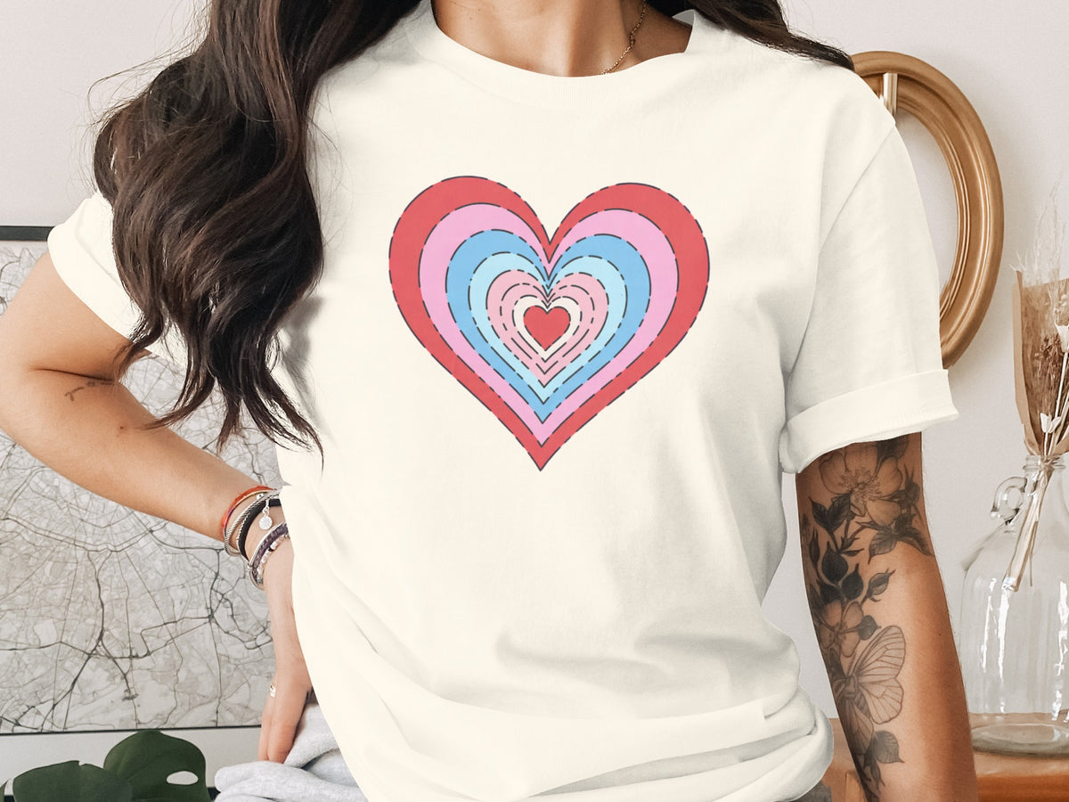 Cream t-shirt with a layered concentric heart design in red, pink, and blue.