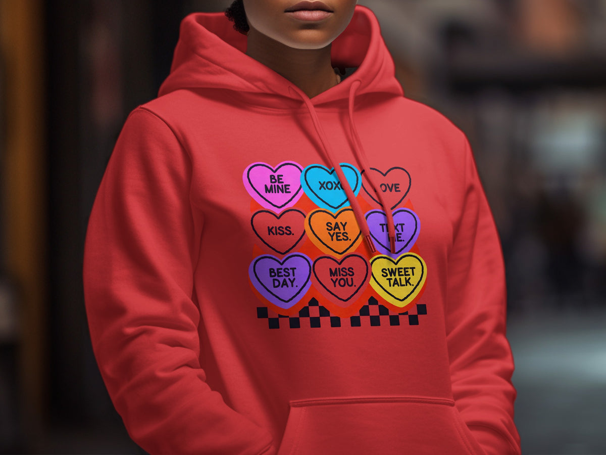 Red hoodie with candy hearts saying "Be Mine," "XOX," "Love," "Kiss," "Say Yes," "Text Me," "Best Day," "Miss You," and "Sweet Talk."