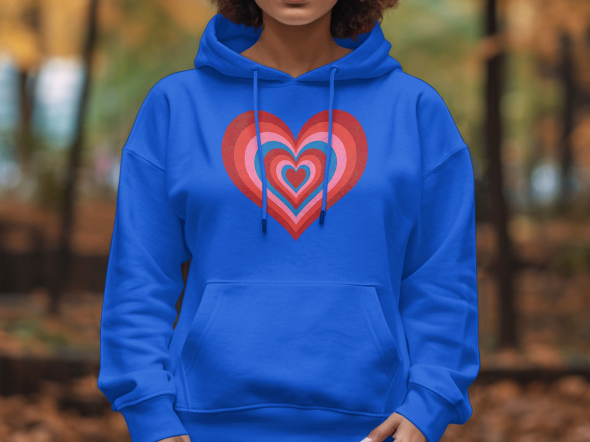 Blue hoodie with a concentric heart graphic in red, pink, and blue.