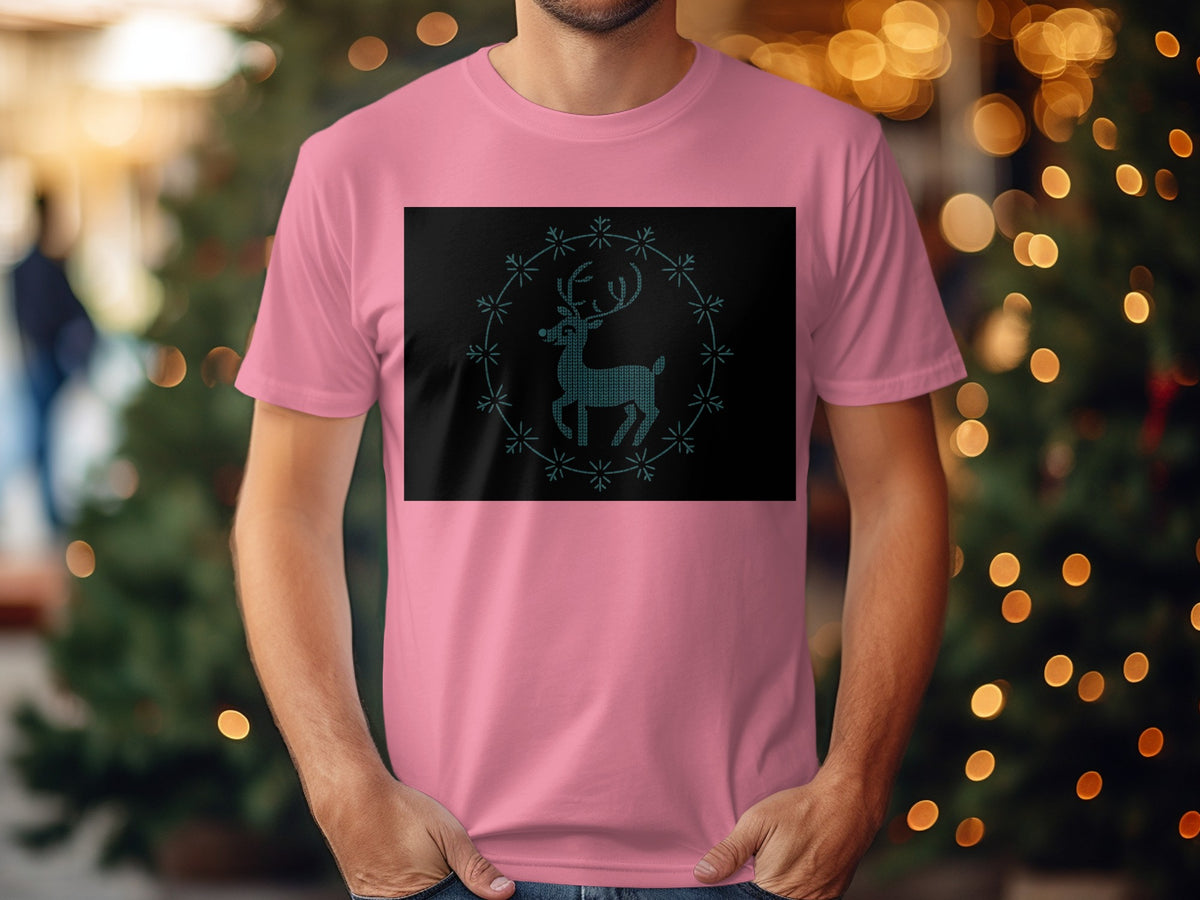 Pink t-shirt with a teal knitted reindeer inside a snowflake circle graphic.