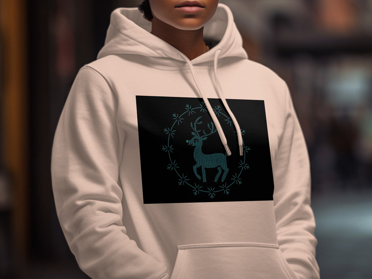 White hoodie with a black square featuring a teal reindeer design within a circular pattern.