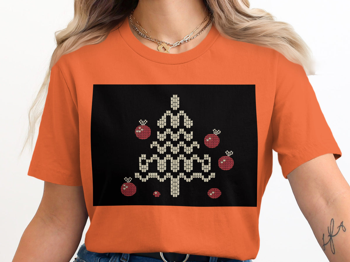 Orange t-shirt with a black box featuring a knitted Christmas tree and ornaments.