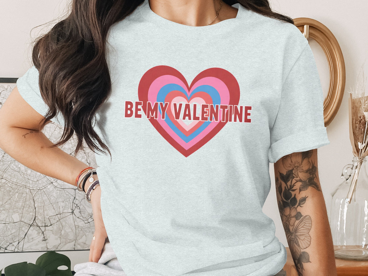 Light gray t-shirt with "BE MY VALENTINE" text over a concentric heart design.