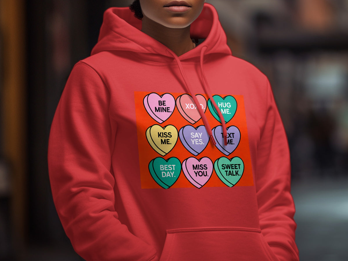 Red hoodie with candy hearts: Be Mine, XOXO, Hug Me, Kiss Me, Say Yes, Text Me, Best Day, Miss You, Sweet Talk.