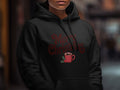 Black hoodie with "Merry Christmas" text and a hot cocoa mug graphic.