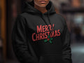 Black hoodie with "MERRY CHRISTMAS" text and holly graphic.