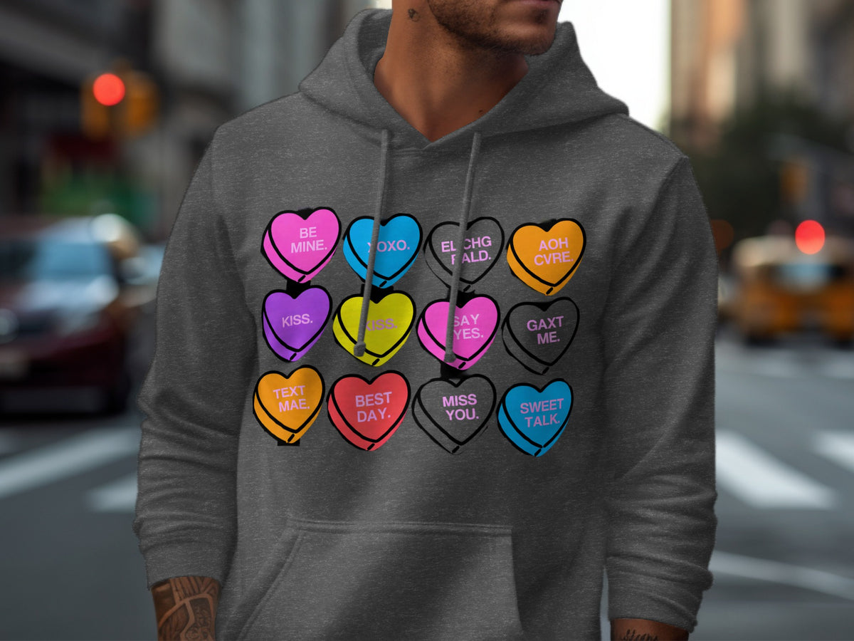 Dark gray hoodie with hearts: BE MINE, OXO, EL CHG FALD, AOH CVRE, KISS, SAY YES, GAXT ME, TEXT MAE, BEST DAY, MISS YOU, SWEET TALK.